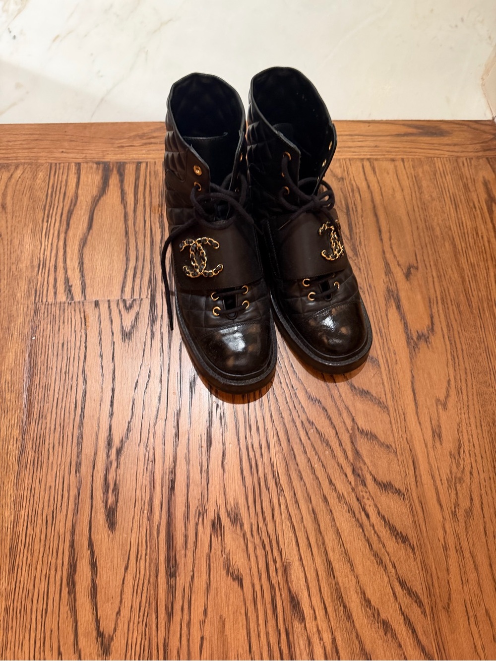 CHANEL Black Quilted Leather Lace-Up Boots with Gold CC Accent
